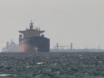 FILE PHOTO: Cargo ships in the Gulf, near the Strait of Hormuz, as seen from northern Ras al-Khaimah, near the border with Oman’s Musandam governance, amid the U.S.-Israeli conflict with Iran, in United Arab Emirates, March 11, 2026. REUTERS/Stringer/File Photo