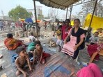 Manju Devi, along with slum children, awaits help to rebuild her classroom to start teaching again. (HT Photo)