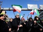 Iranian women brandish their rifles as they take part in a rally dubbed 'Sacrificed Girls' to pay tribute to women killed during the Middle East war in Tehran on April 17, 2026.