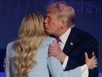 After Kirk introduced Trump with praise, he leaned in and kissed her on the cheek.