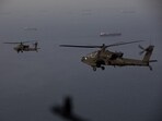 AH-64 Apaches flying above the Strait of Hormuz during a patrol on April 17. Iran's military declared the Strait of Hormuz closed again on April 18.