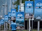 A police personnel walks past posters highlighting Pakistan's mediation of Iran-US peace talks, at the Red Zone area in Islamabad on April 18, 2026. No date has been set for the next round of Iran-US peace talks.