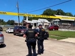 Police officers secure a street where eight children, with ages ranging from 1 to 14, were killed in a mass shooting in Shreveport, Louisiana.
