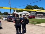 Police officers secure a street where eight children, with ages ranging from 1 to 14, were killed in a mass shooting in Shreveport, Louisiana.