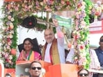 Union home minister Amit Shah waves to a gathering during a roadshow ahead of Tamil Nadu Assembly elections, in Erode, Tamil Nadu (@AmitShah)