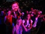 People wait for the start of a Turning Point USA event with Vice President JD Vance at Akins Ford Arena at the Classic Center in Athens, Ga., Tuesday, April 14, 2026. (Chip Somodevilla/Pool via AP)
