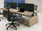 A sleek workstation shifts from sitting to standing, encouraging gentle movement through the day while keeping productivity and comfort in balance.(Interio by Godrej)