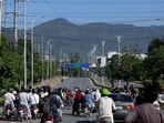 Pakistani police officers and Army soldiers divert the traffic on a road leading to the Serena hotel, the venue for the second phase of peace talks between the United States and Iran hosted by Pakistan, in Islamabad, April 20.