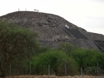 Mexican authorities work on the Pyramid of the Moon at the scene where a man shot dead a Canadian woman and injured several others before killing himself.