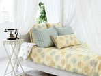 Soft lit bedroom with a tucked mosquito net creates a calm, safe sleep space free from bites and buzzing interruptions. 