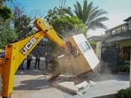 Teams raze structures in Block-J, DLF Phase 2, near Krishana Park on Monday. (Parveen Kumar/HT)