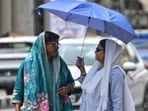 Women cover their faces to shield against scorching heat in Lucknow on Monday. (Mushtaq Ali/HT)
