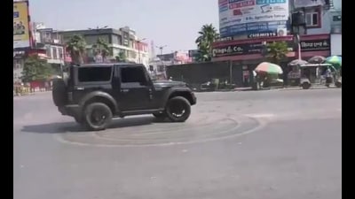 A still from the viral video shows the four-wheeler performing stunts at the busy Subhash Chowk crossing in Prayagraj on Sunday afternoon, forcing commuters to clear the area. (VIDEO GRAB) A still from the viral video shows the four-wheeler performing stunts at the busy Subhash Chowk crossing in Prayagraj on Sunday afternoon, forcing commuters to clear the area. (VIDEO GRAB)