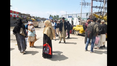 People stand at a bus stand amid a valley-wide “chakka jam” called by the All Jammu and Kashmir Transporters' Welfare Association to protest against the government's proposal to expand Smart City bus services in other districts, in Srinagar on Monday. (ANI)
