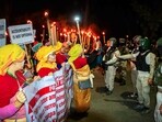 Protestors confront security personnel during a Meira (torch) rally at Koirengei, demanding justice regarding the Tronglaobi killing incident, in Imphal East on Sunday.