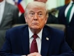 President Donald Trump listens in the Oval Office of the White House, Saturday.