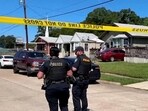 Police officers secure a street where eight children, with ages ranging from 1 to 14, were killed in a mass shooting in Shreveport, Louisiana.