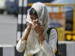 A girl covers her face to protect against the scorching heat in Lucknow on Wednesday (HT Photo)