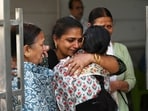 Family members and friends are seen at a residence in the Kailash Hills area of Amar Colony, New Delhi, India, on Wednesday, April 22, 2026, after the daughter of a senior Indian Revenue Service (IRS) official was found dead.