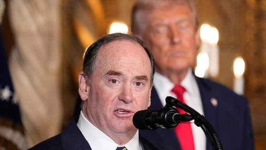 Former Secretary of the Navy John Phelan speaks, as President Donald Trump listens, at Trump's Mar-a-Lago club (AP)