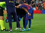 Barcelona's Lamine Yamal holds the back of his leg after getting injured during the Spanish La Liga soccer match between Barcelona and Celta Vigo