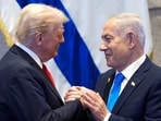 US President Donald Trump holding hands with Israeli Prime Minister Benjamin Netanyahu.