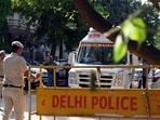Delhi Police officials and forensic team members are seen at a residence in Kailash Hills, Amar Colony area, on Wednesday