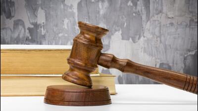 Wooden gavel and books on wooden table Wooden gavel and books on wooden table