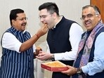 Rajya Sabha MPs Raghav Chadha gets a welcome with sweets from BJP national president Nitin Nabin at the party headquarters in New Delhi on Friday. Tarun Chugh, BJP's national general secretary who is from Punjab, held the box of laddoos. With Chadha were Sandeep Pathak and Ashok Mittal, who also joined the BJP.