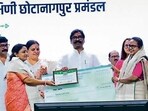 CM Hemant Soren gives away cheques to panchayat representatives at an event on Friday (HT PHOTO)