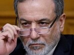 Iranian Foreign Minister Abbas Araqchi adjusts glasses during a press conference following talks
