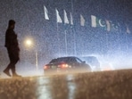 A police officer stands guard as the motorcade, believed to be carrying Iranian Foreign Minister Abbas Araghchi, arrives, as Pakistan prepares to host the U.S. and Iran for the second phase of peace talks, in Islamabad, Pakistan, April 25, 2026. 