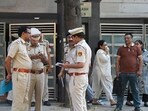 Delhi Police officials and forensic team members are seen at a residence in Kailash Hills, Amar Colony area, in New Delhi.