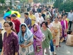 People wait in queues to cast votes during the first phase of the West Bengal Assembly elections, in Asansol, Paschim Bardhaman district