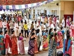 People wait in queues before casting their votes at a polling station in Chennai on Thursday. (PTI)