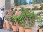 Police conduct checks at a private school in Ludhiana following the threat email on Thursday; and (right) parents gather outside a school to pick up their children. (Gurpreet Singh/HT)