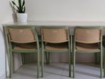 Pastel green rattan-style chairs tucked under a breakfast counter, adding charm, function, and a fresh modern touch effortlessly. (Hindustan Times)