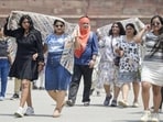 Visitors to the Red Fort shield themselves from the heat. (RAJ K RAJ /HT PHOTO)