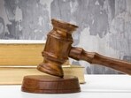 Wooden gavel and books on wooden table