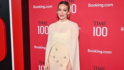 Hilary Duff walked down the red carpet in a cream-colored gown from the Anna October Spring 2026 collection. The floor-length, semi-sheer column dress was embellished with subtle, sparkling circular details and paired with a matching sheer cape that drapes over the shoulders. The actor completed her look with beautiful drop earrings and her hair tied in a bun. (Evan Agostini/Invision/AP) Hilary Duff walked down the red carpet in a cream-colored gown from the Anna October Spring 2026 collection. The floor-length, semi-sheer column dress was embellished with subtle, sparkling circular details and paired with a matching sheer cape that drapes over the shoulders. The actor completed her look with beautiful drop earrings and her hair tied in a bun. (Evan Agostini/Invision/AP)