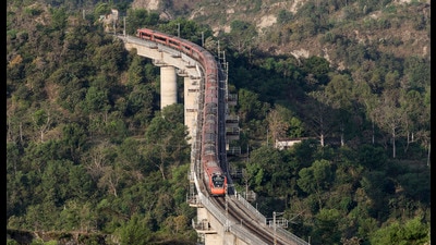 A Vande Bharat Express train crosses a bridge near Bajalta vllage while en route to Katra station, on Friday. (PTI) A Vande Bharat Express train crosses a bridge near Bajalta vllage while en route to Katra station, on Friday. (PTI)