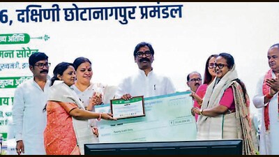CM Hemant Soren gives away cheques to panchayat representatives at an event on Friday (HT PHOTO)