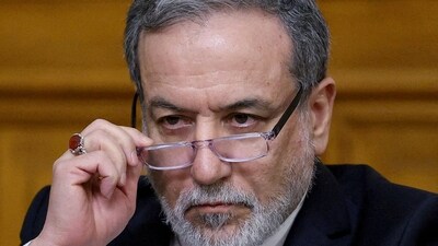 Iranian Foreign Minister Abbas Araqchi adjusts glasses during a press conference following talks (REUTERS)