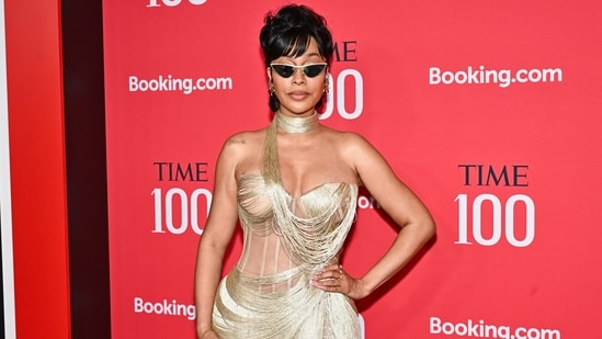 La La Anthony was a showstopper on the red carpet, wearing a custom-made, gold-toned fringe and lace gown designed by Pajtim Raci. The dress featured intricate metallic fringe detailing, a sheer corset-style bodice, and a high thigh-slit. She accessorised with a matching choker, pointed-toe heels, and cat-eye sunglasses.&nbsp;(Evan Agostini/Invision/AP)
