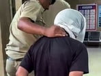 Accused Rahul Meena  being brought to Amar Colony Police Station, in New Delhi on Thursday. (ANI Video Grab)