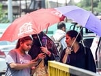 People protecting themselves by using umbrellas from the heatwave during a hot summer day on Saturday. (ANI Photo)