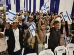 Members of the Bnei Menashe (Sons of Manasseh) community from India wave Israeli flags as they arrive at Ben Gurion Airport in Lod, near Tel Aviv, on April 23 Members of the Bnei Menashe (Sons of Manasseh) community from India wave Israeli flags as they arrive at Ben Gurion Airport in Lod, near Tel Aviv, on April 23