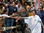 West Bengal CM and TMC candidate from Bhabanipur, Mamata Banerjee greets supporters during a roadshow ahead of the second phase of the state assembly elections, in Kolkata on Friday, April 24.