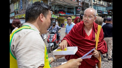 A man offers sweets to a monk on the occasion of the 37th birth anniversary of 11th Panchen Lama, at McLeodGanj Main Square, in Dharamshala,on Saturday. (PTI) A man offers sweets to a monk on the occasion of the 37th birth anniversary of 11th Panchen Lama, at McLeodGanj Main Square, in Dharamshala,on Saturday. (PTI)