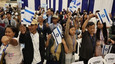 Members of the Bnei Menashe (Sons of Manasseh) community from India wave Israeli flags as they arrive at Ben Gurion Airport in Lod, near Tel Aviv, on April 23 (AFP) Members of the Bnei Menashe (Sons of Manasseh) community from India wave Israeli flags as they arrive at Ben Gurion Airport in Lod, near Tel Aviv, on April 23 (AFP)